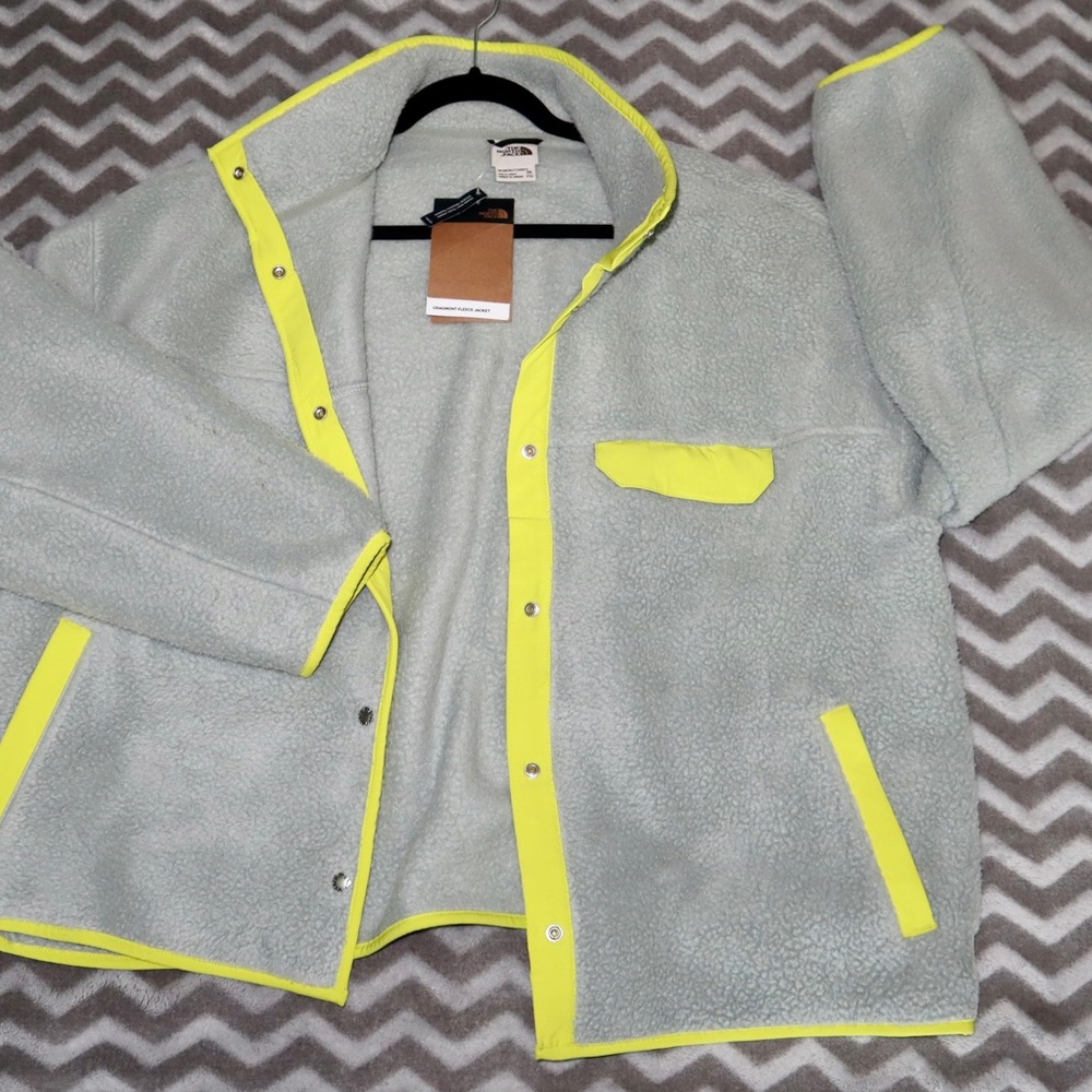 The north face fleece jacket. Blueish/grey color with neon yellow trim.